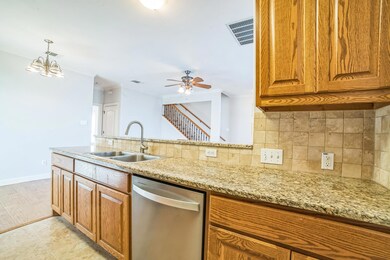 Kitchen with dishwasher, ornamental molding, ligh