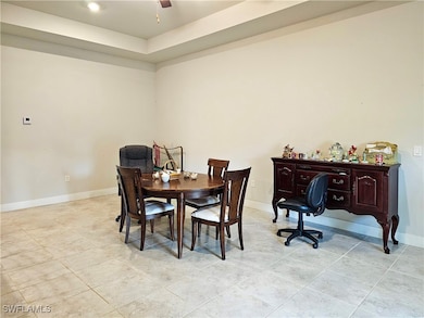 Dining space featuring light tile patterned floors