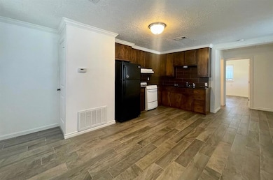 Kitchen with visible vents, freestanding refrigera