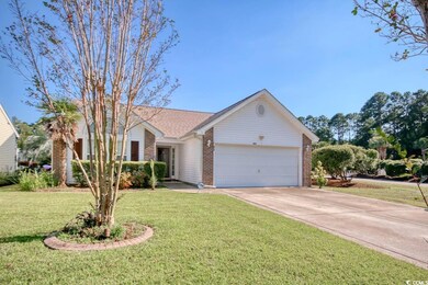 Ranch-style house with a front yard and a garage