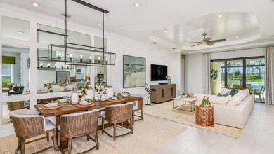 Tiled dining area featuring ornamental molding, visible vents, recessed lighting, and ceiling fan with notable chandelier