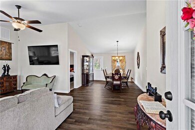 Living room with dark wood finished floors, lofted