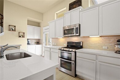 Kitchen with stainless steel appliances, light co