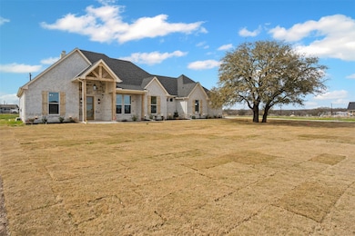 View of front of house with brick siding and a fro