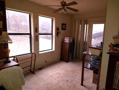 Bedroom featuring multiple windows and light color