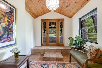 Property entrance featuring french doors