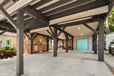 View of parking / parking lot featuring a carport