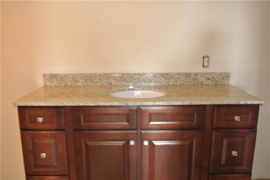 cherry cabinetry and granite countertops in upstai