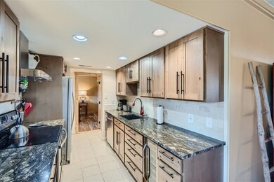 Kitchen with wall chimney exhaust hood, stainless