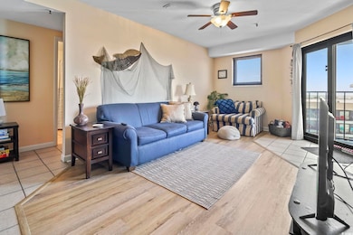 Living area with a ceiling fan and light wood-style flooring