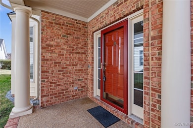 Doorway to property with brick siding