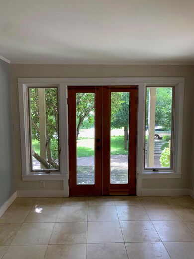 Doorway featuring baseboards, french doors, and a