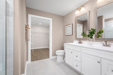 Bathroom with vanity, a shower with shower door, t