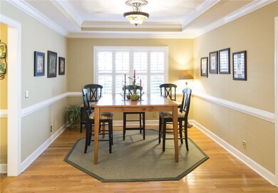 Large dining room with hardwood floors and tray ce
