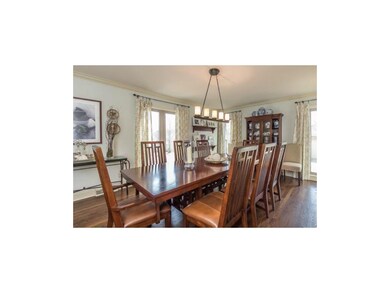 Dining room with large windows, crown molding, and
