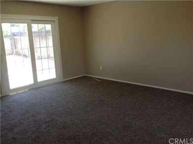 Spacious living room with dual pane sliding doors 