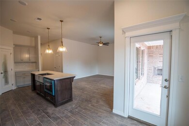 Kitchen featuring a kitchen island, tasteful backs