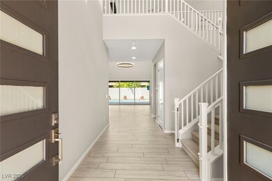 Foyer entrance with a towering ceilingstairway, li