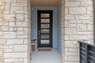 Doorway to property featuring stone siding