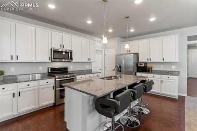 Kitchen featuring sink, dark wood-type flooring, a