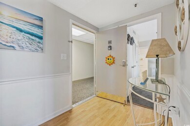 Corridor with baseboards, a paneled ceiling, and wood finished floors