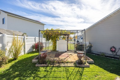 Fenced backyard with a patio area