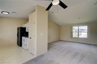 Unfurnished living room featuring ceiling fan, lig