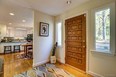 Foyer has hardwood floors and recessed lights
