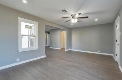 Empty room with baseboards, visible vents, a ceili