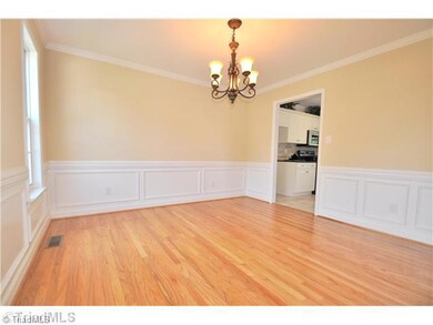 Dining Room. Formal Dining Room with hardwoods is highlighted by a new chandelier and boxes for a rich, elegant look.