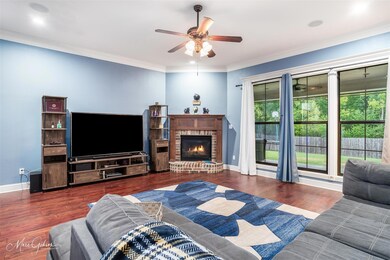 Living room with ceiling fan, ornamental molding, 