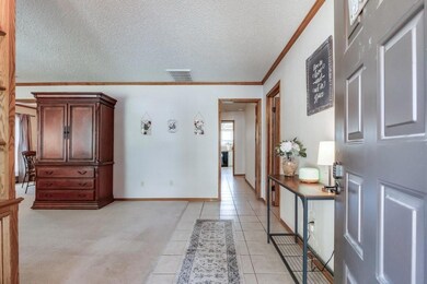 Foyer entrance with light carpet, a textured ceili