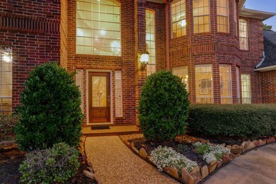 Welcoming entryway with beautiful landscaping.