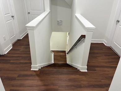 Stairway featuring wood finished floors