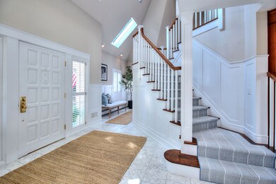 Majestic floating staircase, soaring ceilings, sun-drenched rooms and an open concept layout.