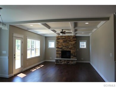 Family Room with Cofferred Ceiling and Stone Firep