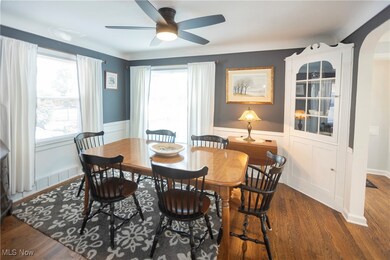 Dining space with dark wood-type flooring and ceiling fan