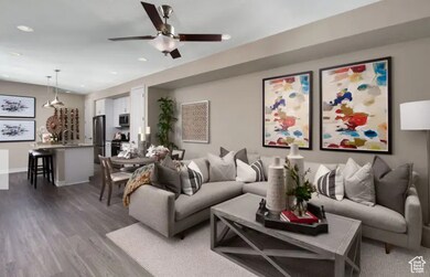 Living room featuring dark wood finished floors, recessed lighting, and ceiling fan