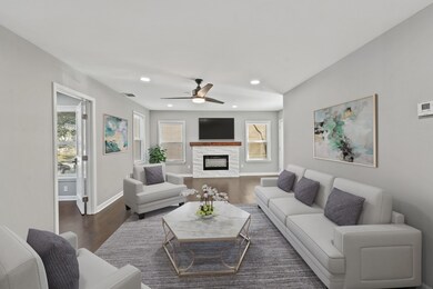 This living room is gorgeous and is seamlessly connected to the kitchen and breakfast area creating one amazing space! Beautiful views of the backyard are provided by the incredible windows. making this spacious, open living room bright and perfect for entertaining!