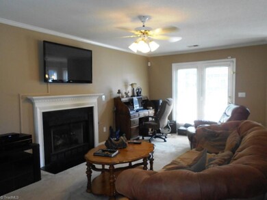 Large family room with french doors leading out to the back yard.
