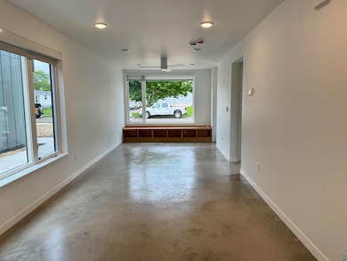 Spare room with finished concrete floors, ceiling fan, and recessed lighting