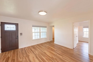 Foyer entrance with baseboards and light wood-sty
