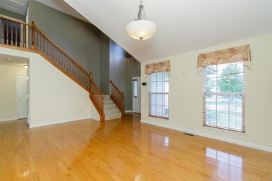 A two-story entry foyer and open staircase welcome
