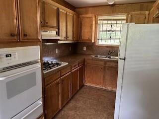 Kitchen featuring exhaust hood, white appliances, 