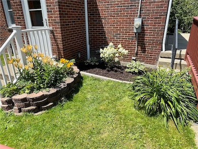Mature landscaping/flowers on side entrance