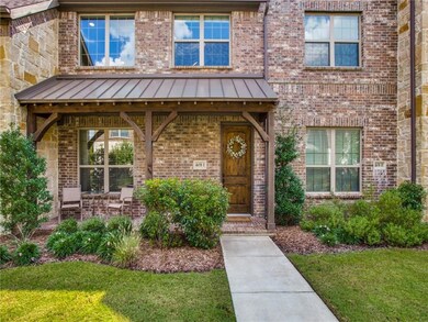Covered front porch overlooks beautifully landscap