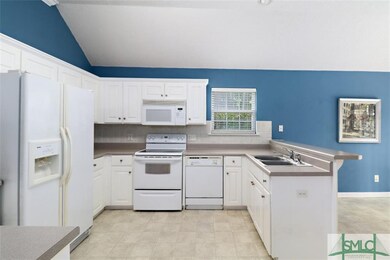 Open kitchen offers white appliances and double co