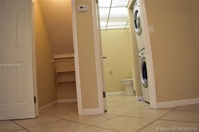 Storage plus half bathroom with washer and dryer.