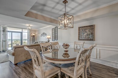 Dining room with a notable chandelier and dark woo