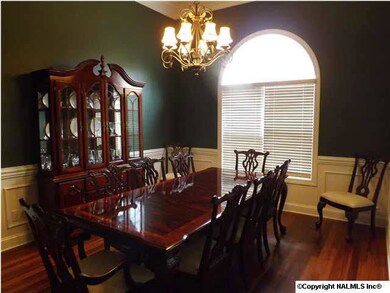 Elegant Dining Room with 12' Ceiling, Deep Crown Moulding, Large Picture Window, Wainscoting